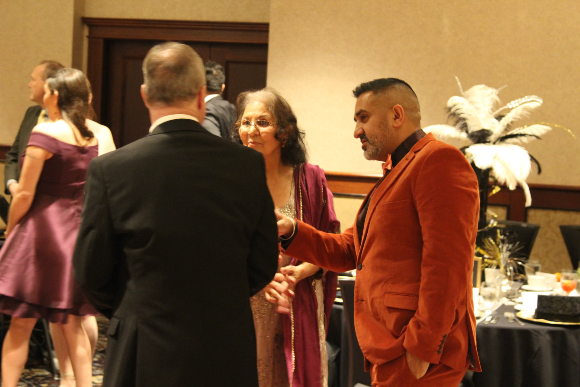 Mike Manhas speaking with guests at a community event