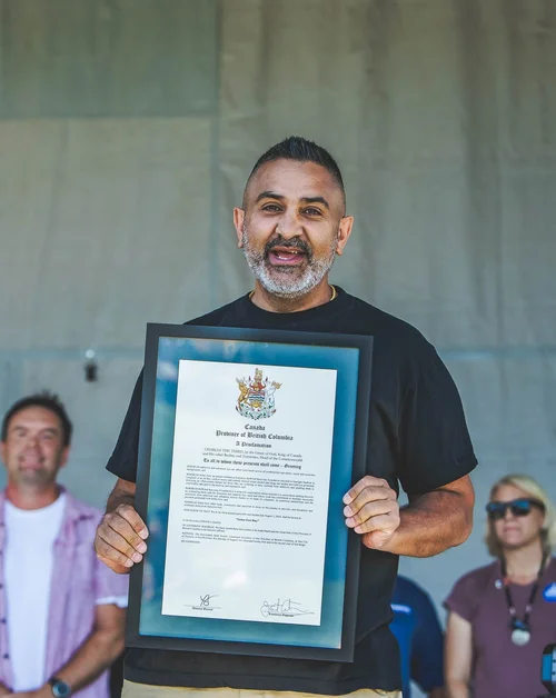 Mike Manhas holding a Province of British Columbia proclamation